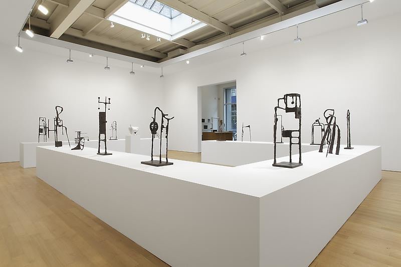 installation view of tables with abstract sculptures