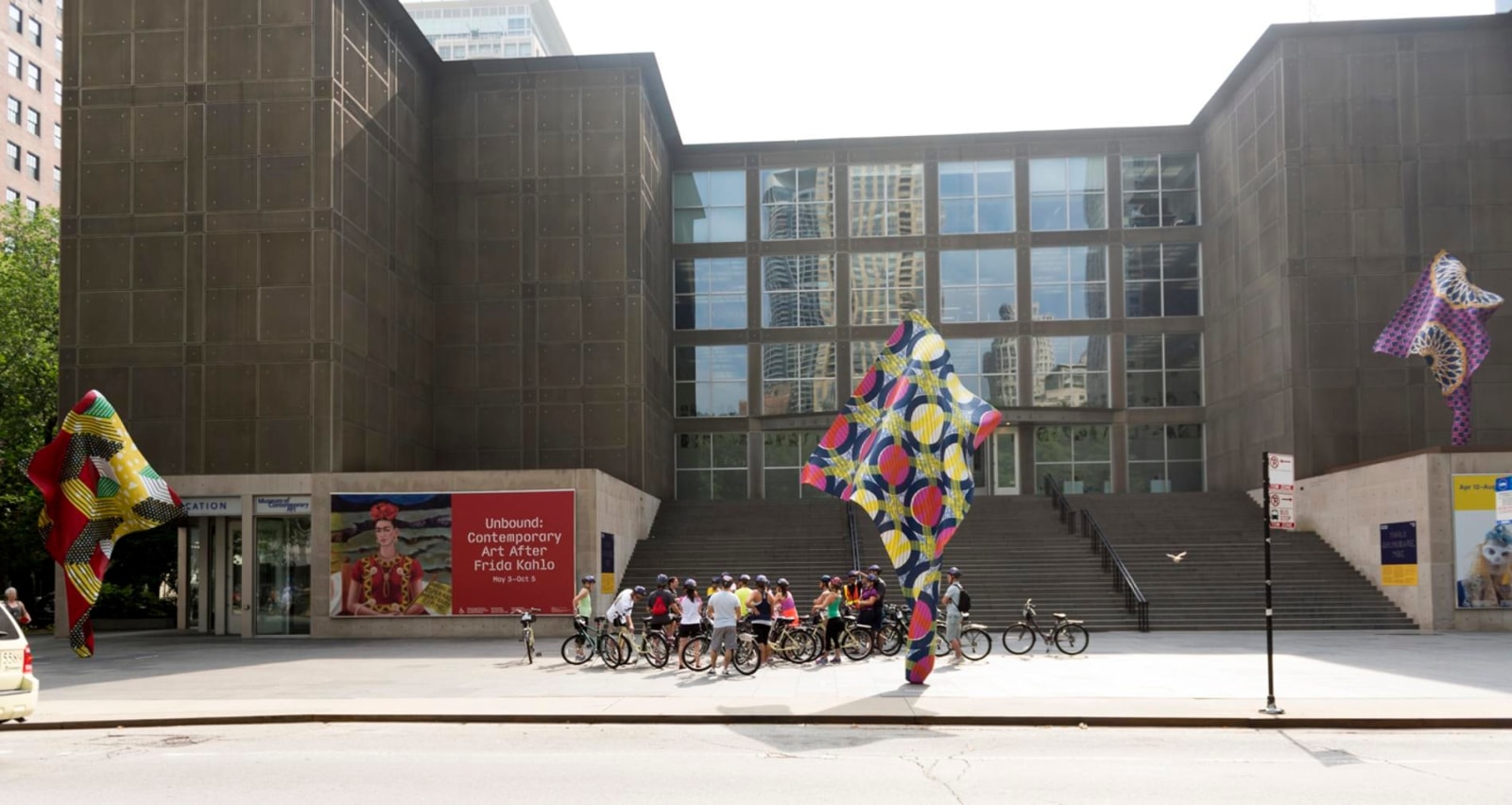 multiple sculptures of swaying and undulating fabric standing outside of the Museum of Contemporary Art Chicago