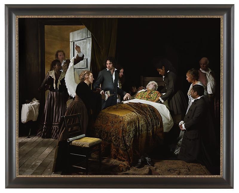 a pale man layingin bed surrounded by a crowd dressed in black