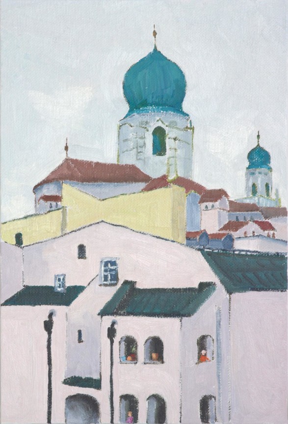 cityscape towered by a church tower with a green roof