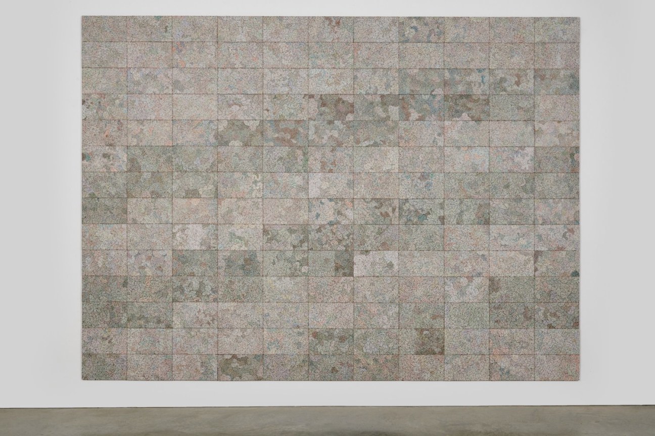 electrical wires on a panel divided into rectangles of slightly different hues