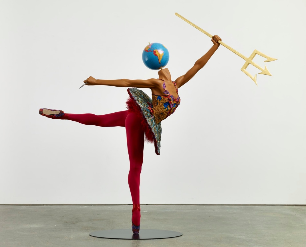 mannequin with a globe for a head dancing ballet and holding a trident