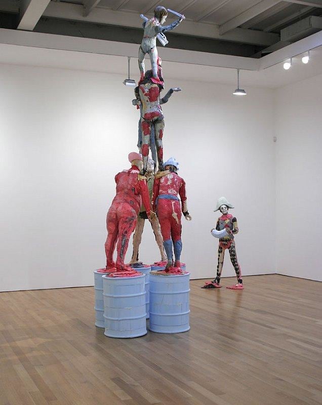 view of statues forming a human pyramid