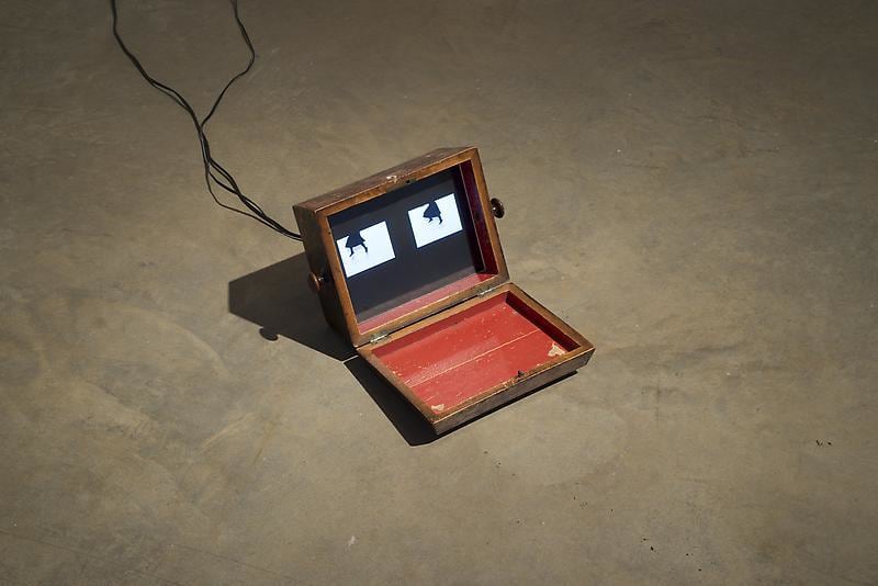 small wooden box containing two videos