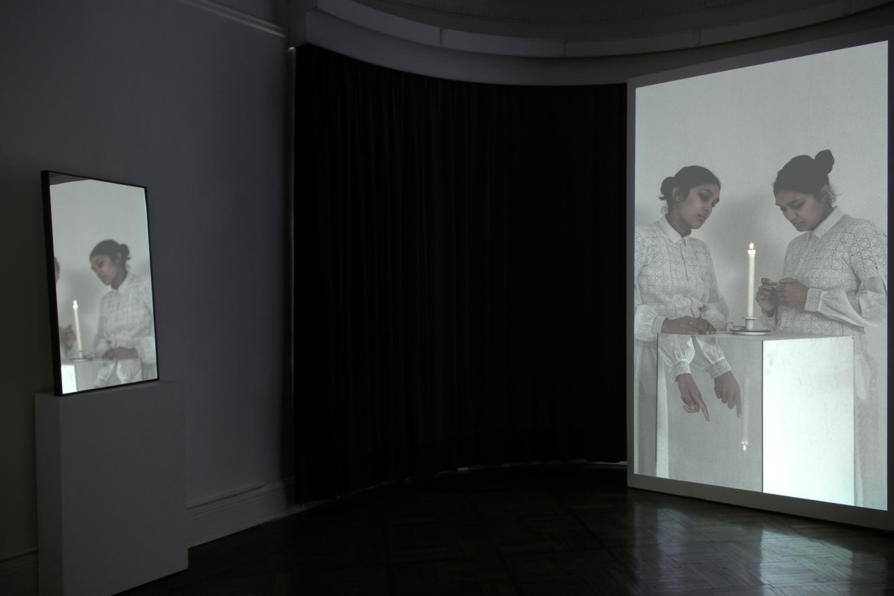 video projection reflected on a mirror across the room