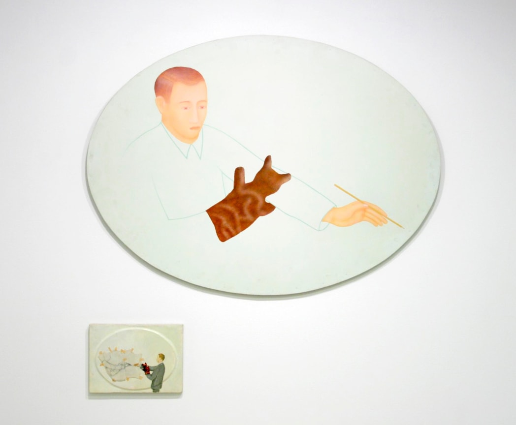 a figure holding a pencil in one hand and a sock puppet in the other; below it there is another canvas with a figure casting a fishnet