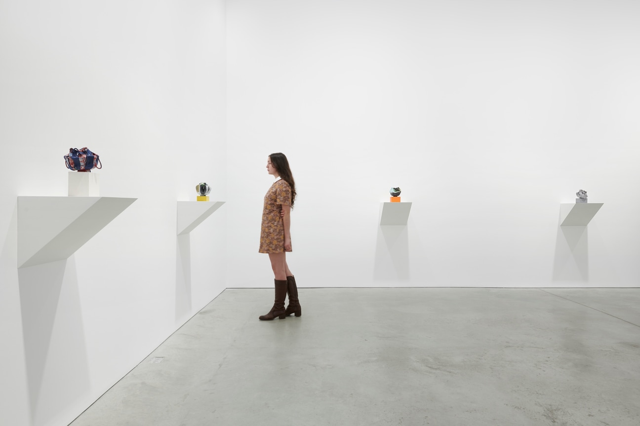 person looking at one of four artworks