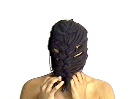 person using their own hair as a mask