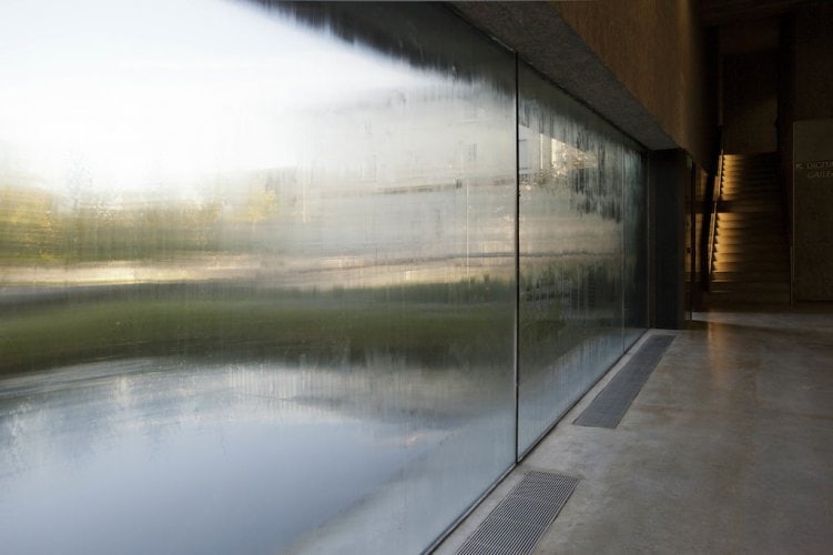 Glass panels coated in sweat from t-shirts worn over a period of time, blurring the outside view