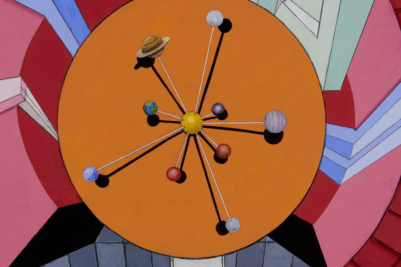 model of the solar system on an orange, circular table