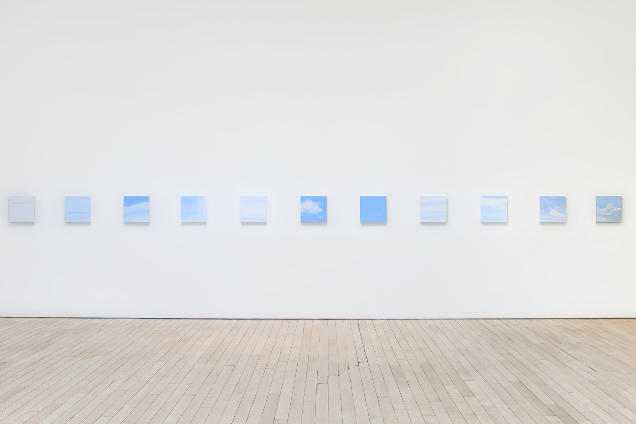 installation view of several square canvases in a row