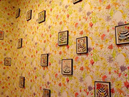 close up of floral wallpaper along with artworks by Trenton Doyle Hancock
