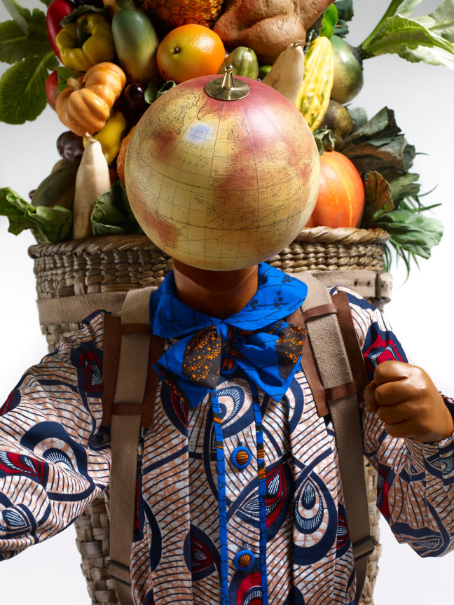 close up of a mannequin with a globe for a head wearing a flamboyant shirt