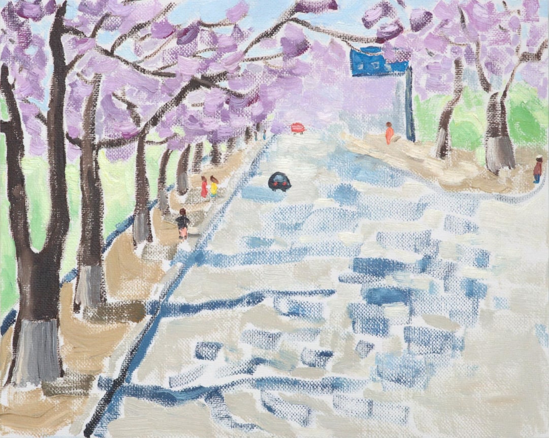 street lined with pink-leaved trees