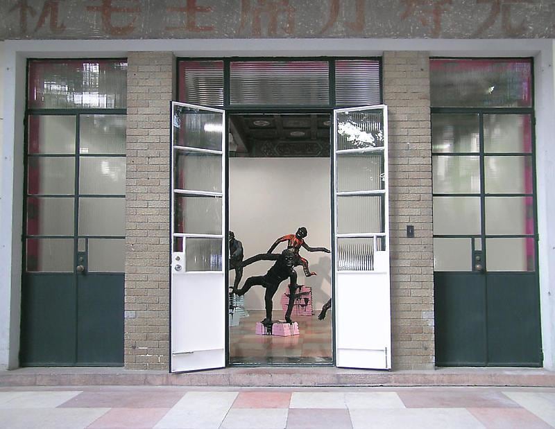 apes standing on pink and blue pedestals