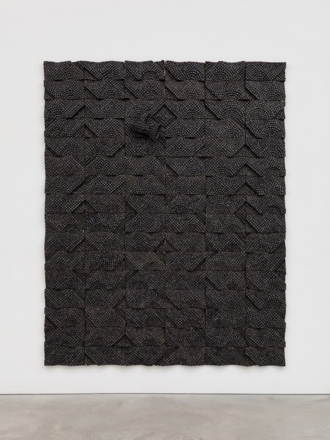 one megaphone composed of electrical components emerging from a pane which also contains electrical components, all in black