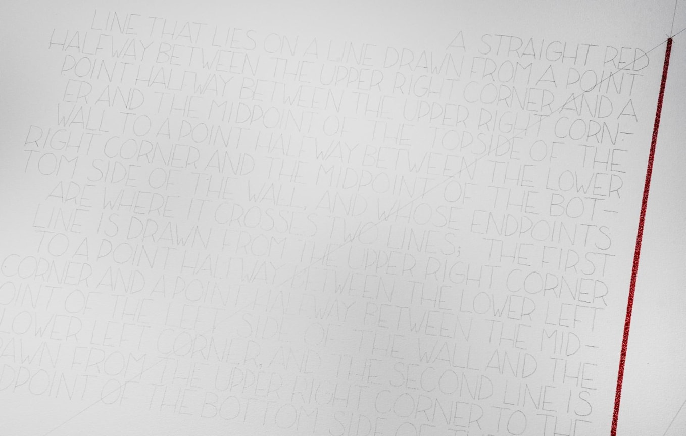 text next to a red line drawn directly on the wall