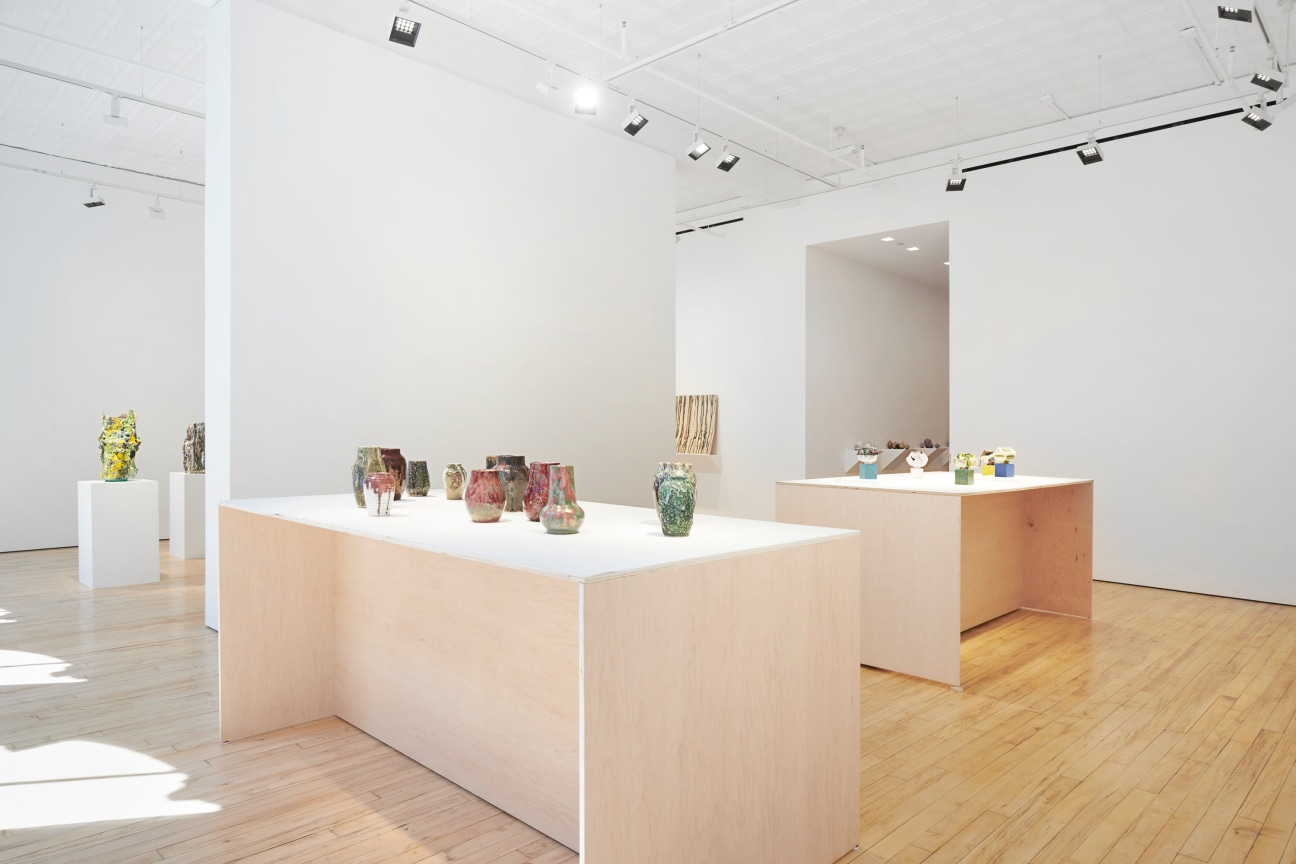 several small sculptures on top of two tables