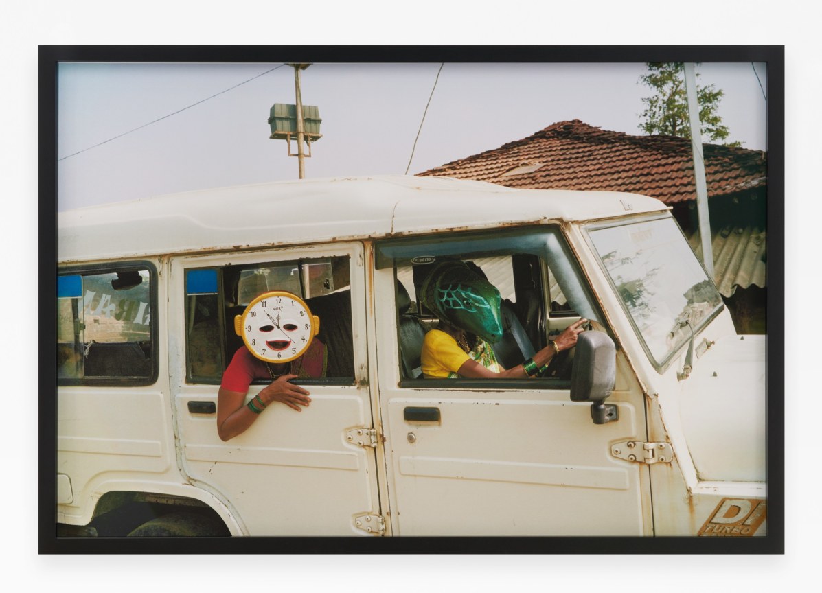 Archival pigment print featuring two people in paper Mache masks