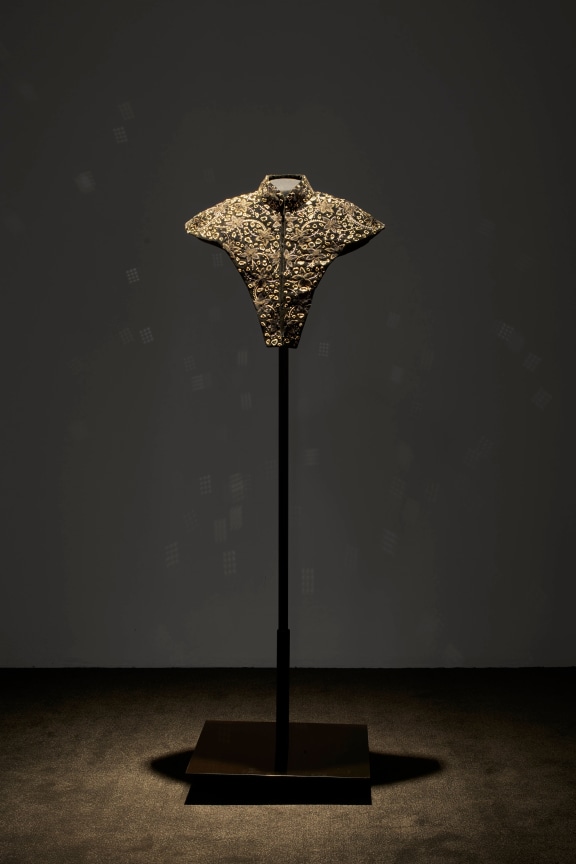 neck piece in a dimly lit room