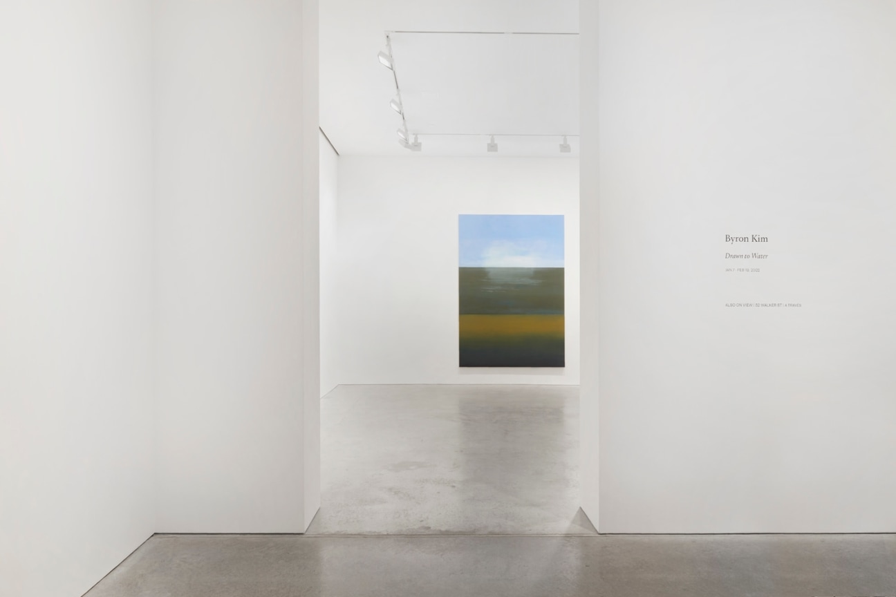 entrance into exhibition with view of a painting