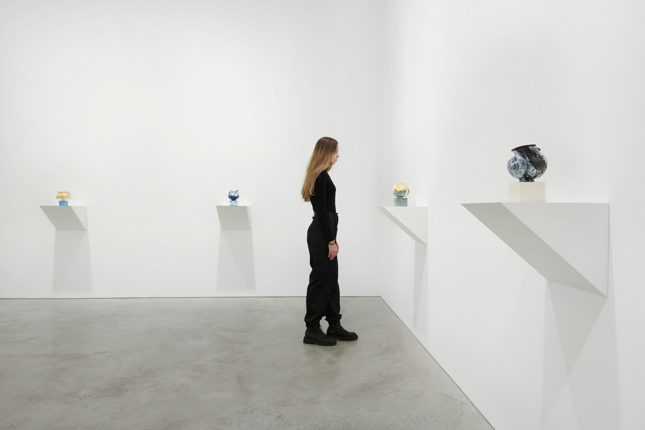 person looking at one of four artworks