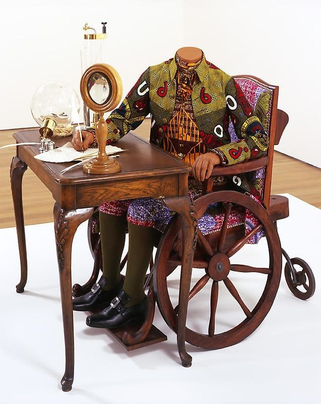 mannequin on a wheelchair writing