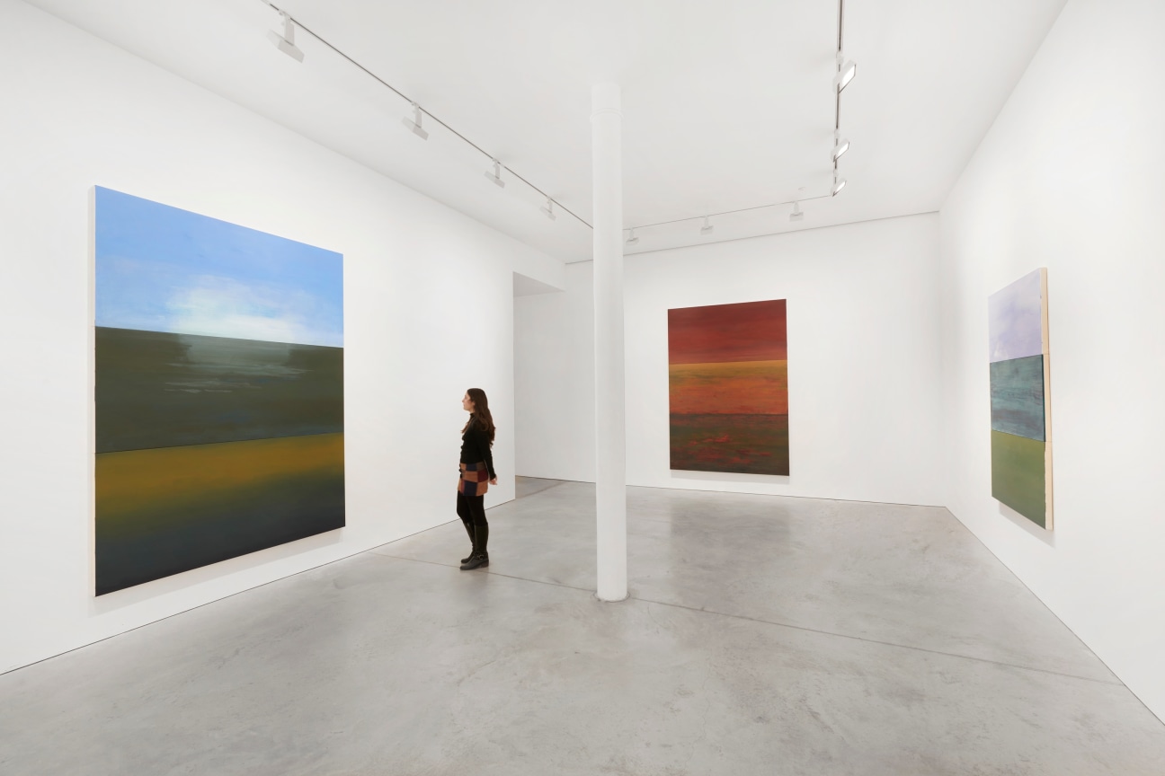 person viewing one of three paintings