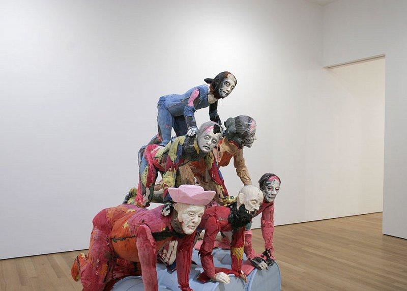 statues forming another human pyramid