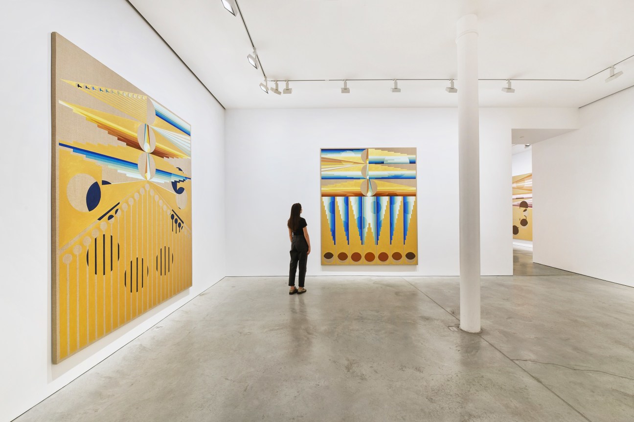 person observing one of two large paintings