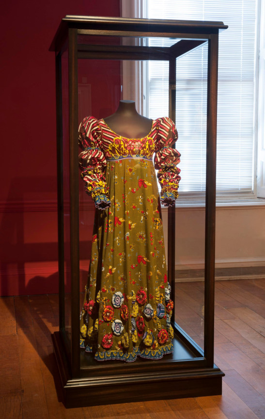 a flamboyant dress with a floral green skirt and striped top
