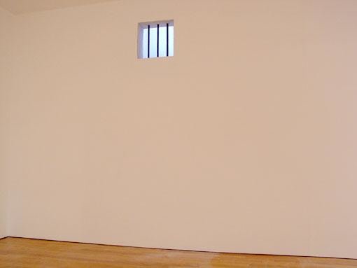 small, barred window high up on the wall