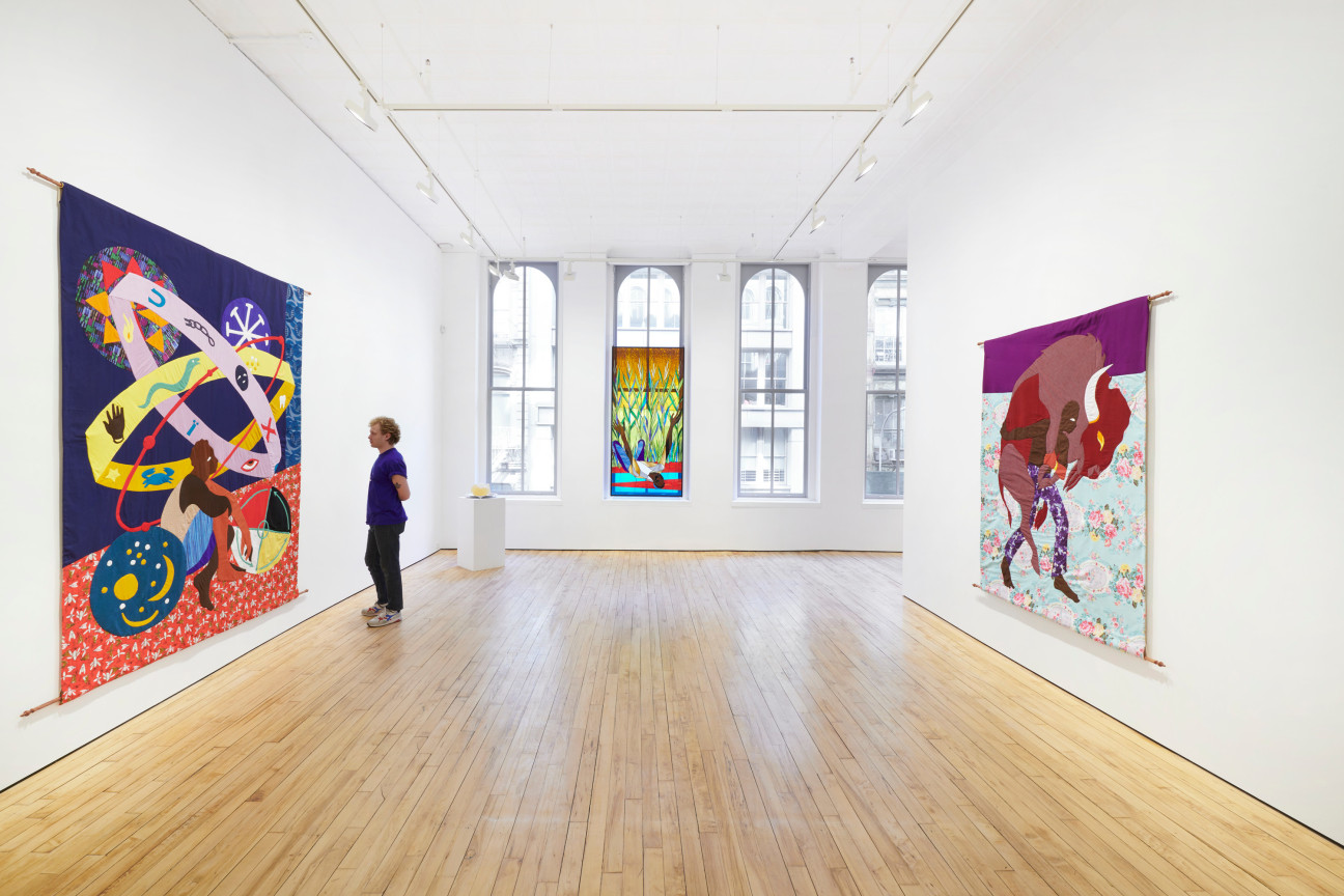 person looking at a tapestry