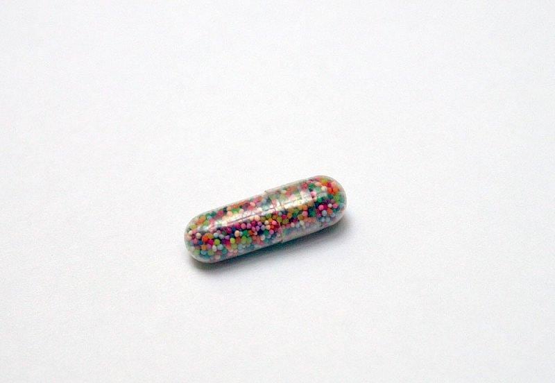 tint pill containing colorful beads