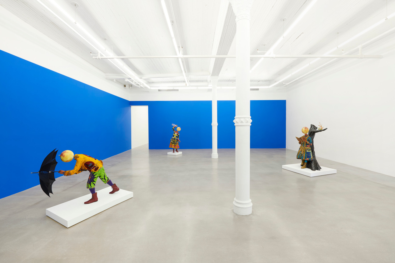 view of three elaborately dressed mannequins