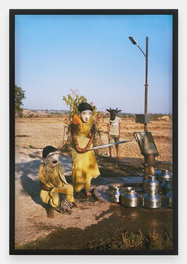 Three masked figures engaging in everyday village activities in Maharashtra, India