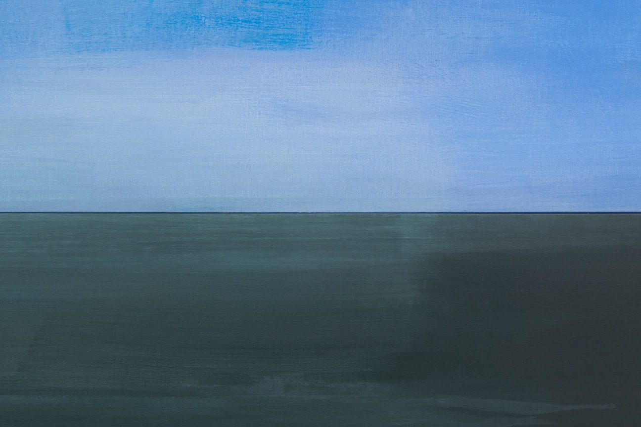 An abstract depiction of half light blue sky and half bluish grey ocean