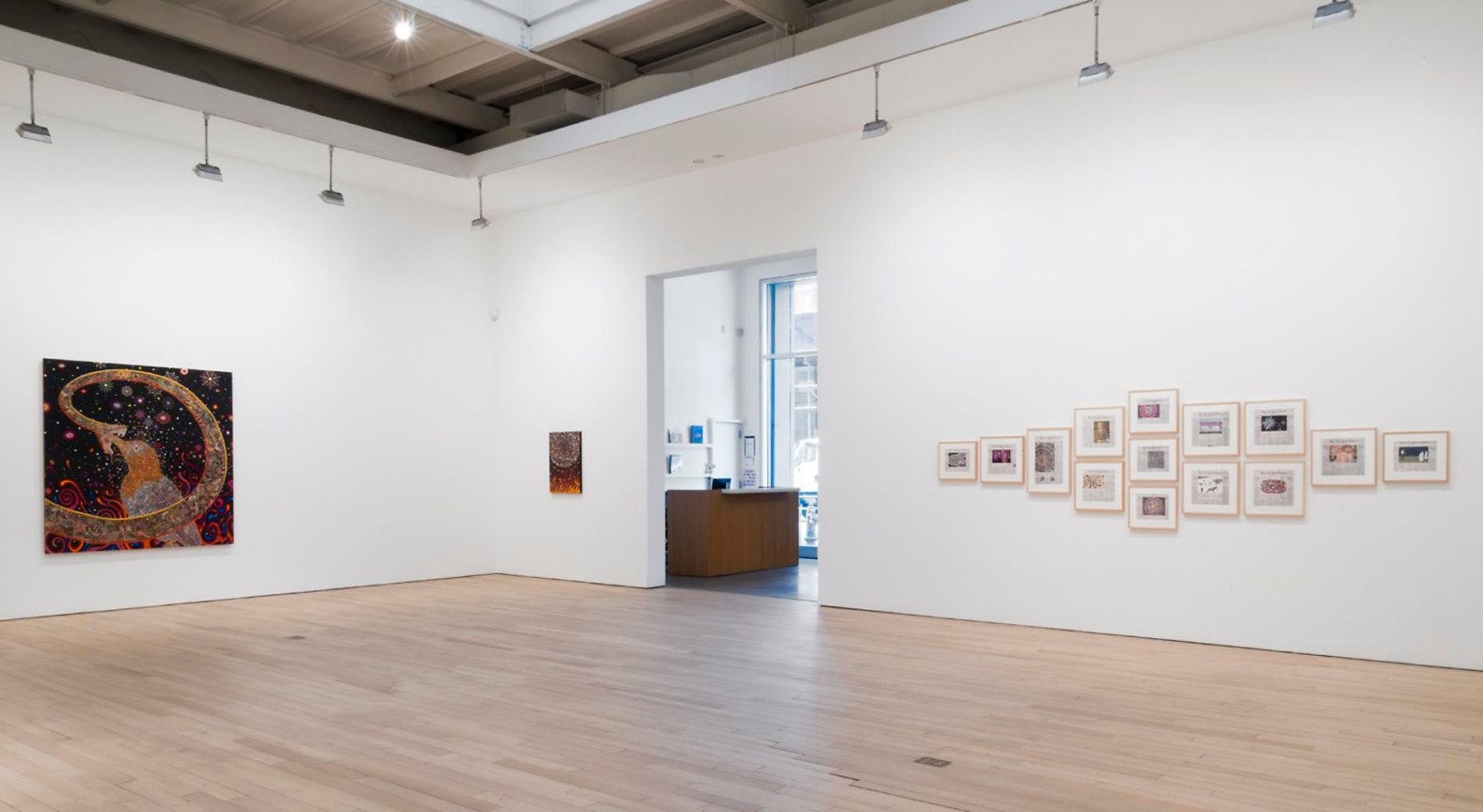 installation view of several artworks with view of reception area