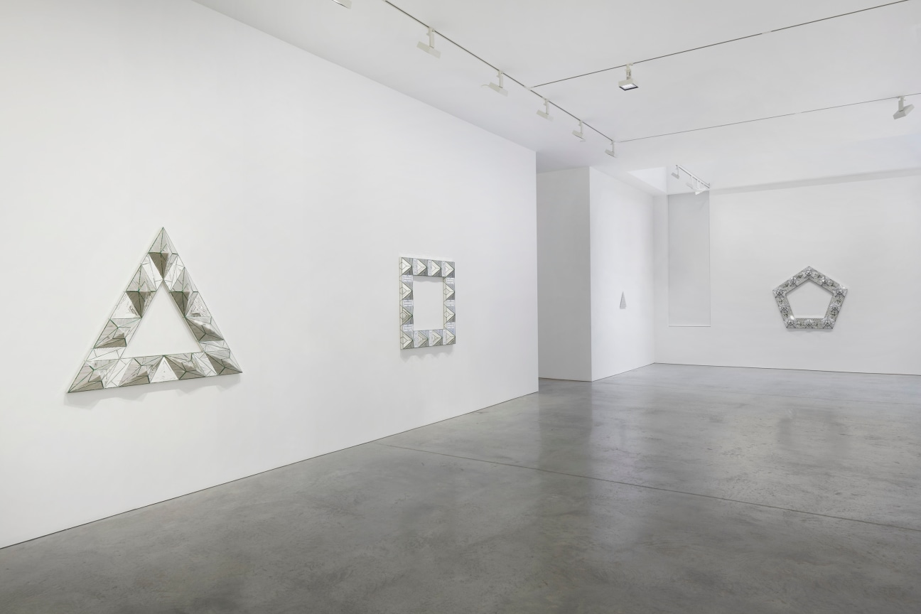 view of three glass artworks within a gallery