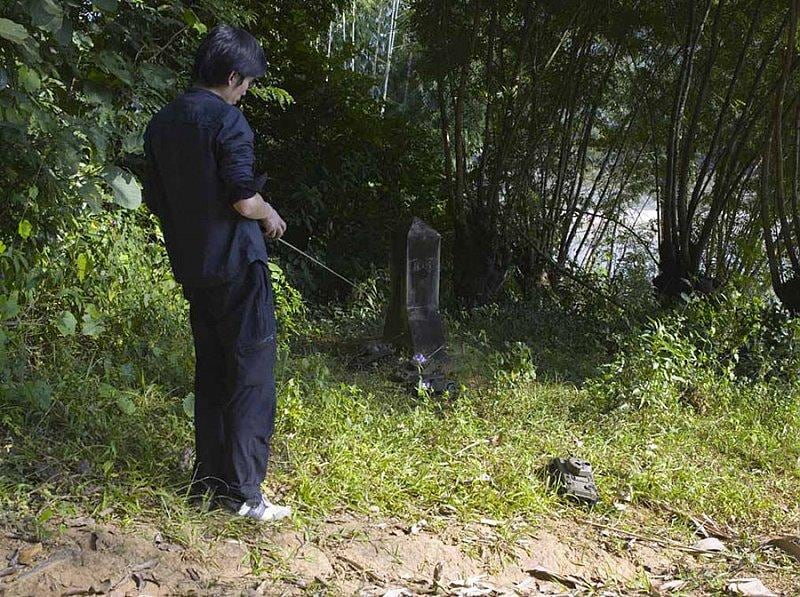 man controlling a tiny tank with a remote control