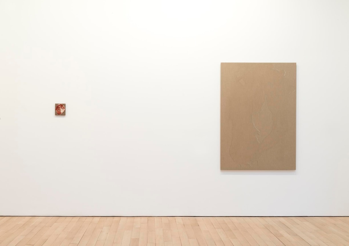 installation view of one very large artwork next to a tiny artwork