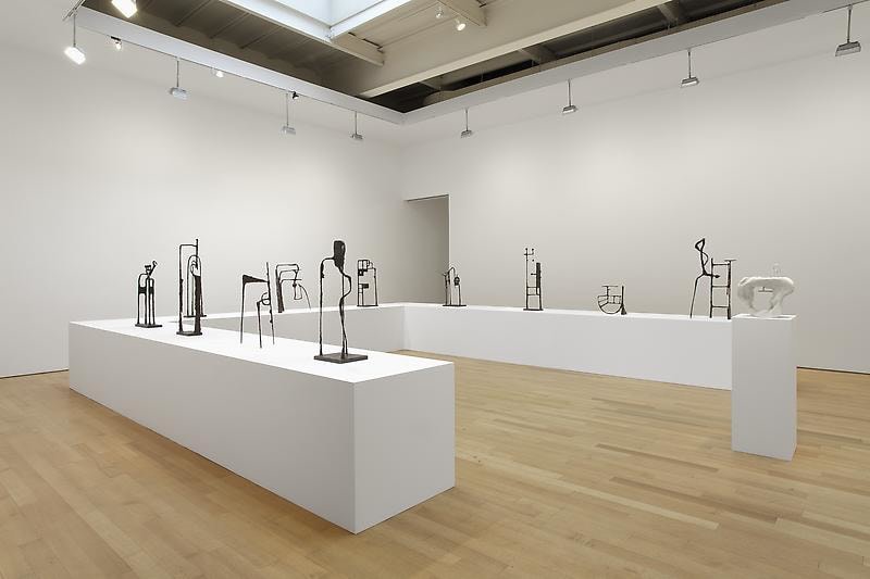 installation view of tables with abstract sculptures