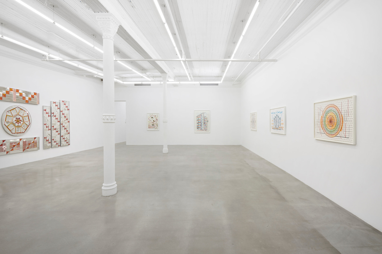 white gallery with several artworks