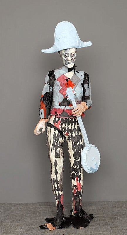 happy statue holding a banjo