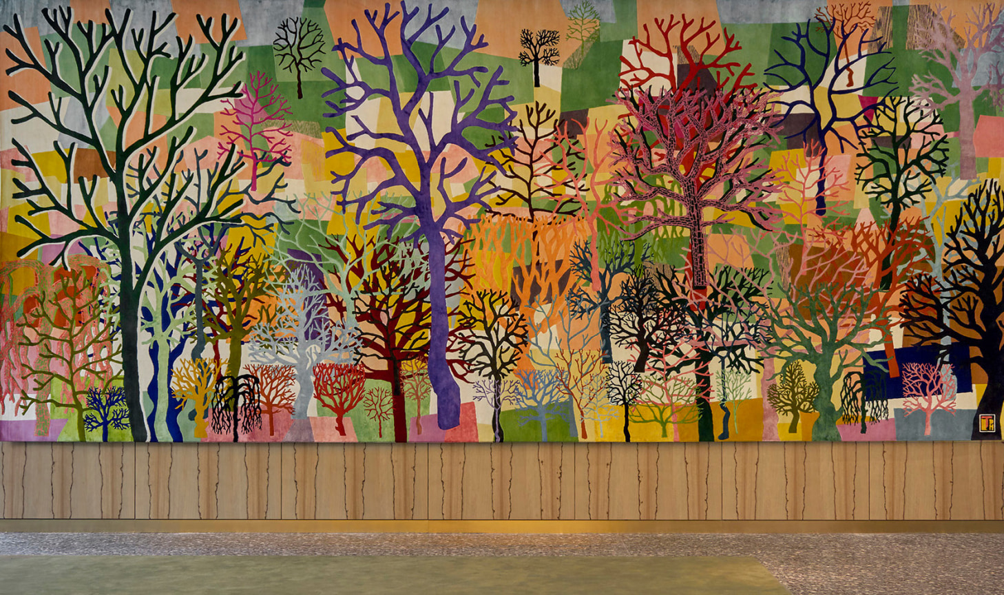 Two identical woven silk and wool tapestries featuring trees of various colors