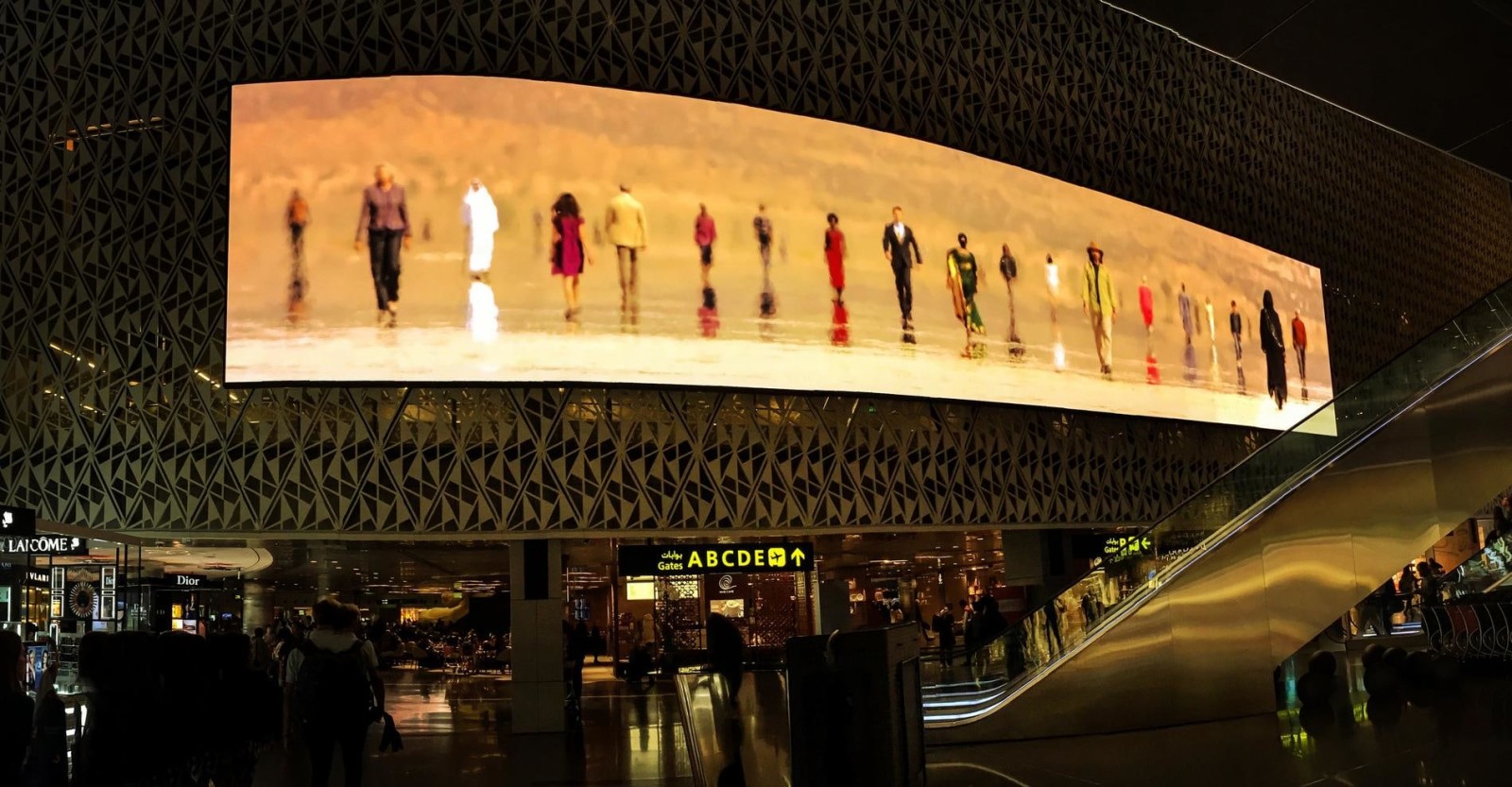 video of people walking in the heat over an airport setting