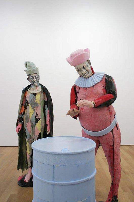 two statues around a barrel