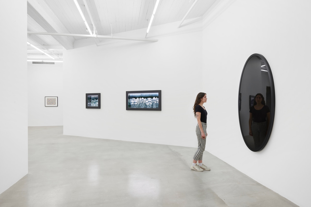 person looking at a large black oval