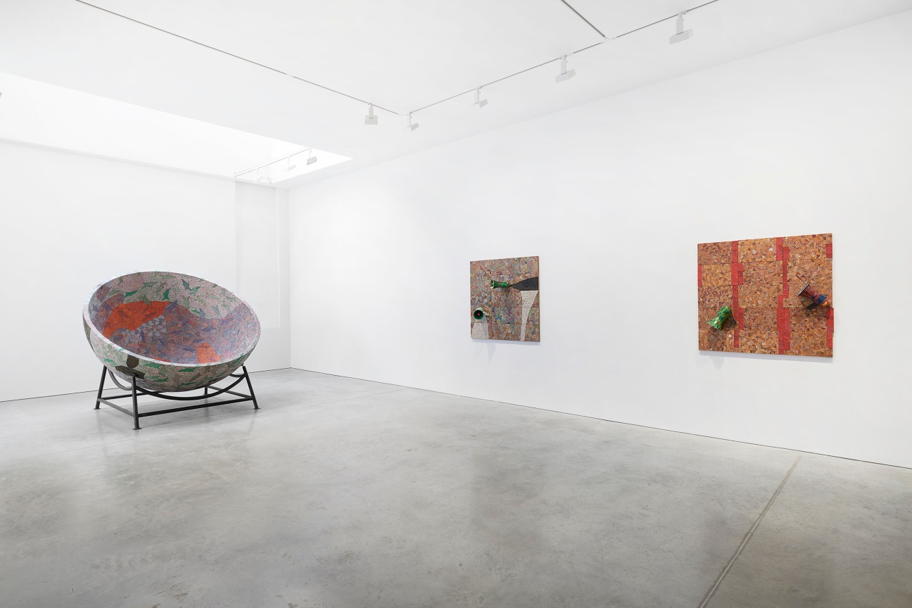 two artworks hanging on the wall and a large sculpture