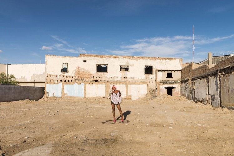Transgender sex worker standing on the dance floor of a demolished night club